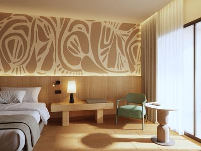 Bright hotel room with double bed, nightstand, armchair, and large window with curtains.