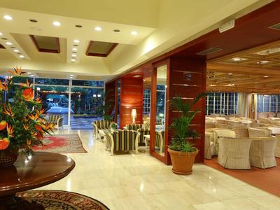 Hotel lobby with seating area and banquet hall, well-lit and elegantly furnished.