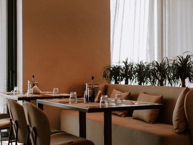 Cozy restaurant seating area with beige walls and warm lighting