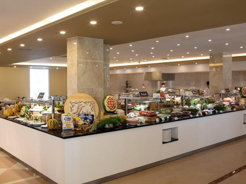 Buffet area in a hotel with various dishes and modern lighting