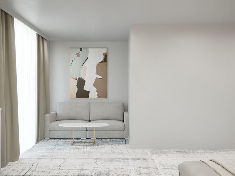 Camera d'hotel moderna con divano, grande finestra e arredi minimalisti.