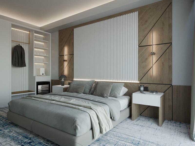 Camera d'hotel moderna con letto grande, comodini e illuminazione indiretta a parete.