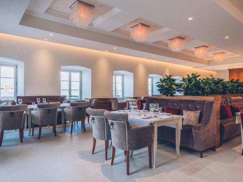 Bright restaurant with modern design, comfortable chairs, and decorative plants.