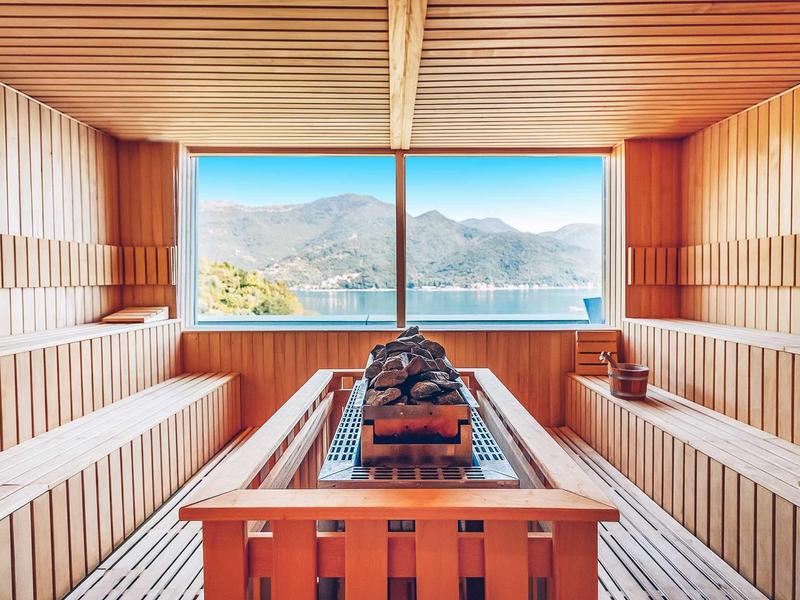 Wooden sauna with large windows and mountain view in a hotel
