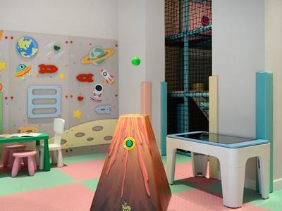 Espace de jeux coloré pour enfants avec table d’activités volcan et mur d’escalade dans un hôtel ou centre de vacances.