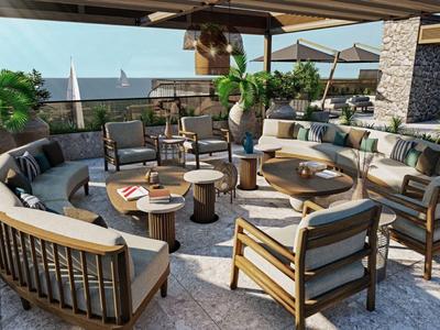 Prostorná lounge terasa s moderním posezením a výhledem na moře.