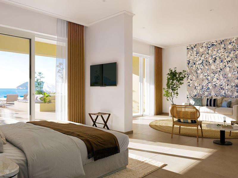 Hell eingerichtetes Hotelzimmer mit Blick auf das Meer und moderner Ausstattung.