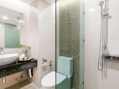 Modern bathroom with sink, toilet, and shower area in a bright design.