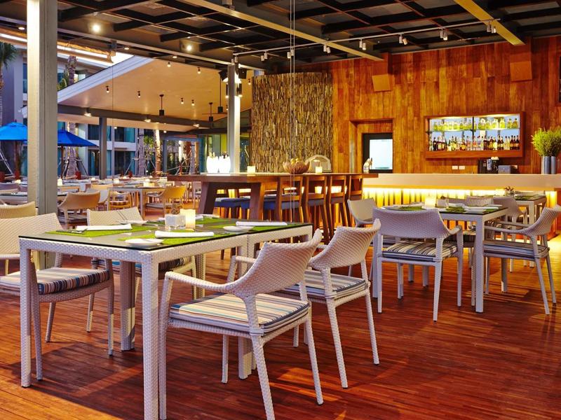 Modern dining area with wooden floor and stylish chairs.
