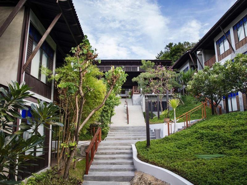 Stairway path between buildings with greenery and trees in hotel complex