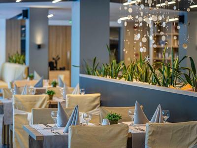 Modern restaurant met gedekte tafels en comfortabele stoelen in een stijlvolle sfeer.