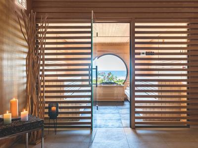 Modern secure entrance with wooden lattice door and candles in a hotel.