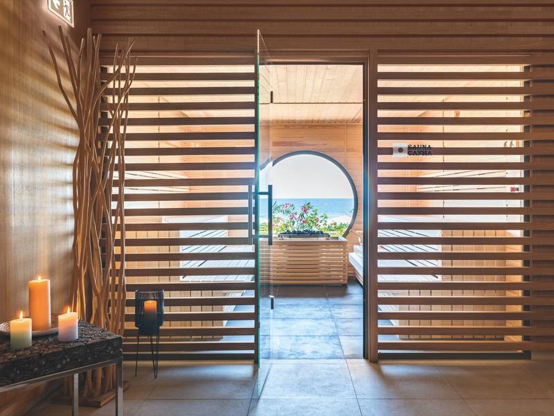 Modern secure entrance with wooden lattice door and candles in a hotel.