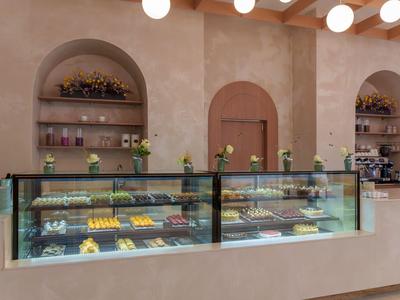 Modern hotel and vacation cake and dessert counter with elegant design and pastel-colored interior.