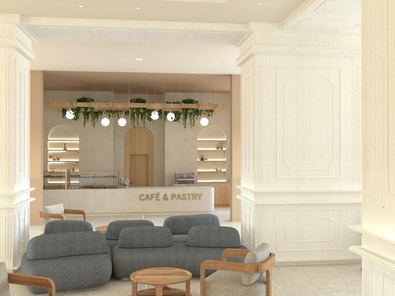 Espace lounge d'hôtel lumineux avec canapés gris, tables en bois et éclairage moderne.