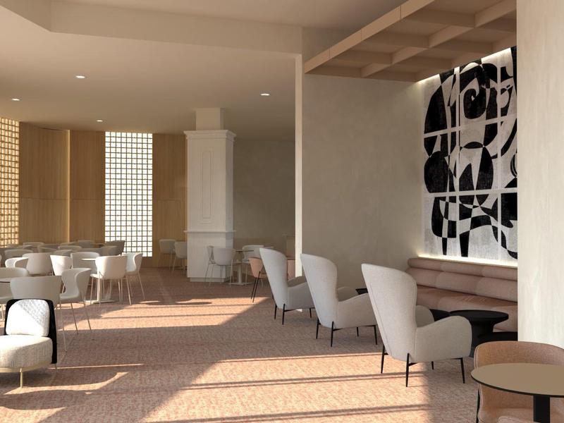 Salon d'hôtel moderne avec fauteuils confortables et art mural abstrait sous une lumière chaude.