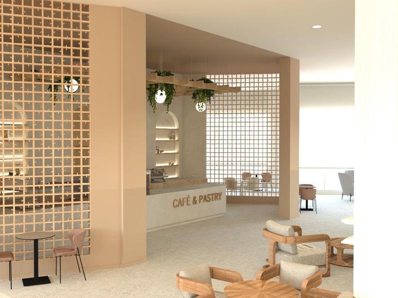 Café moderne avec du bois clair, des tables rondes et des plantes décoratives devant un mur clair.