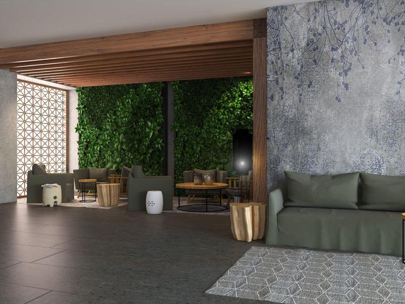 Moderní obývací prostor s pohovkou a otevřeným přístupem k venkovnímu posezení obklopenému zelení.