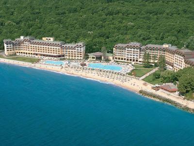 Luxury resort on a forested coastline with pool and beach