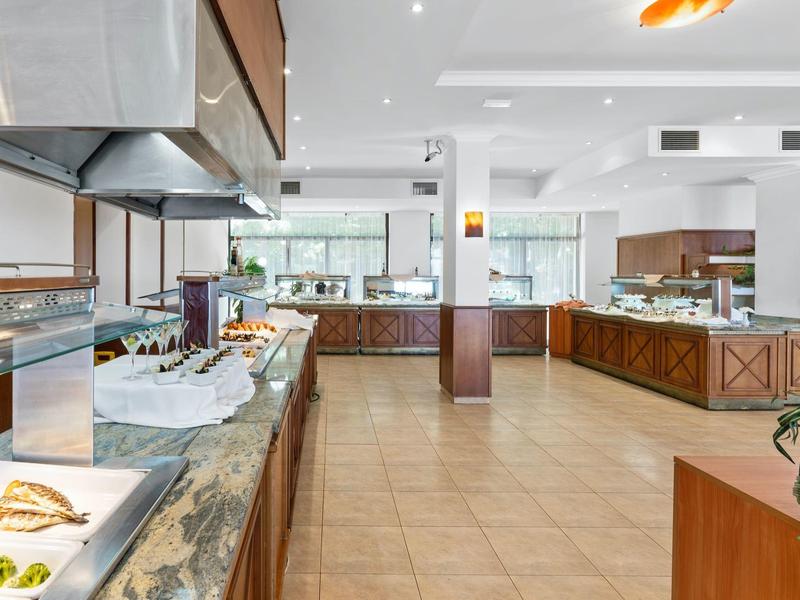 Hotel buffet area with various dishes and wooden paneling.
