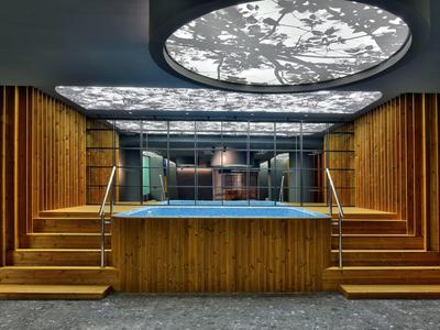 Indoor area with wood paneling, built-in pool, and illuminated ceiling feature