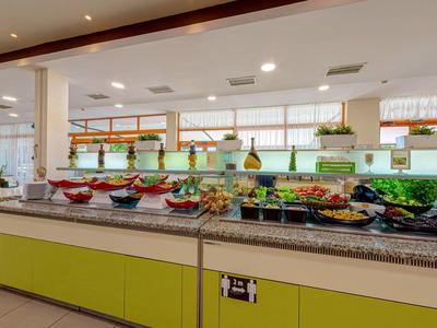 Buffet with various fresh foods in a bright dining area.