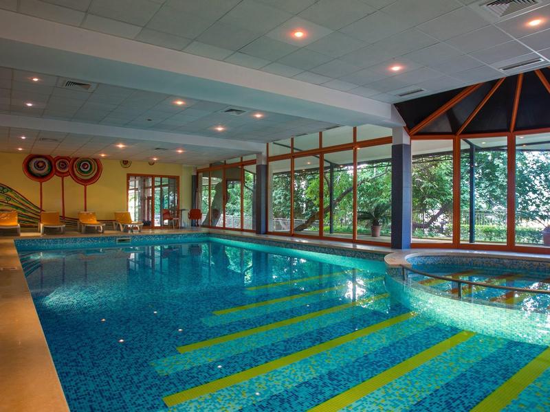Indoor pool with large windows and hot tub in a hotel