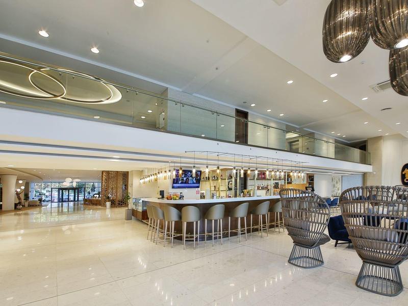 Moderní hotelová lobby s barem, sezením a exkluzivním designem.