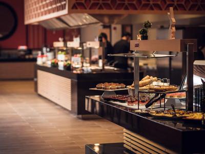 Buffetruimte met verschillende gerechten en warmtelampen in een restaurant