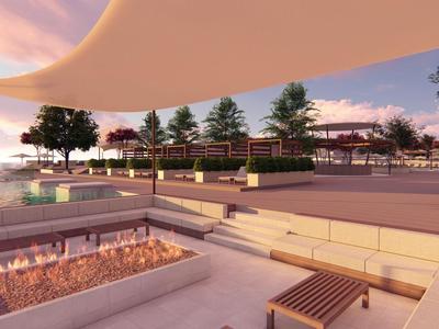 Area esterna moderna con posti a sedere, piante e cielo al tramonto