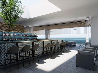 Moderner Hotelbarbereich mit Sitzgelegenheiten und Meerblick durch große Fenster.