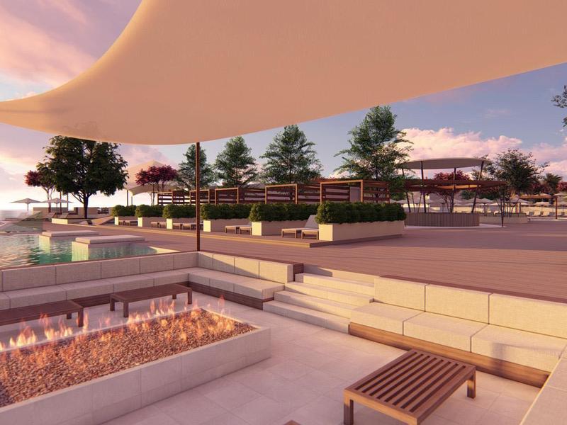 Area esterna moderna con posti a sedere, piante e cielo al tramonto