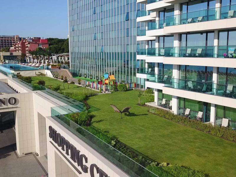 Jardin sur le toit verdoyant d'un hôtel moderne avec vue sur la ville et entrée du casino