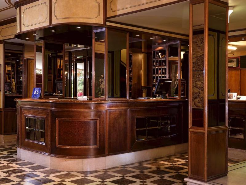 An elegant wooden hotel reception area with classic design elements and lighting.