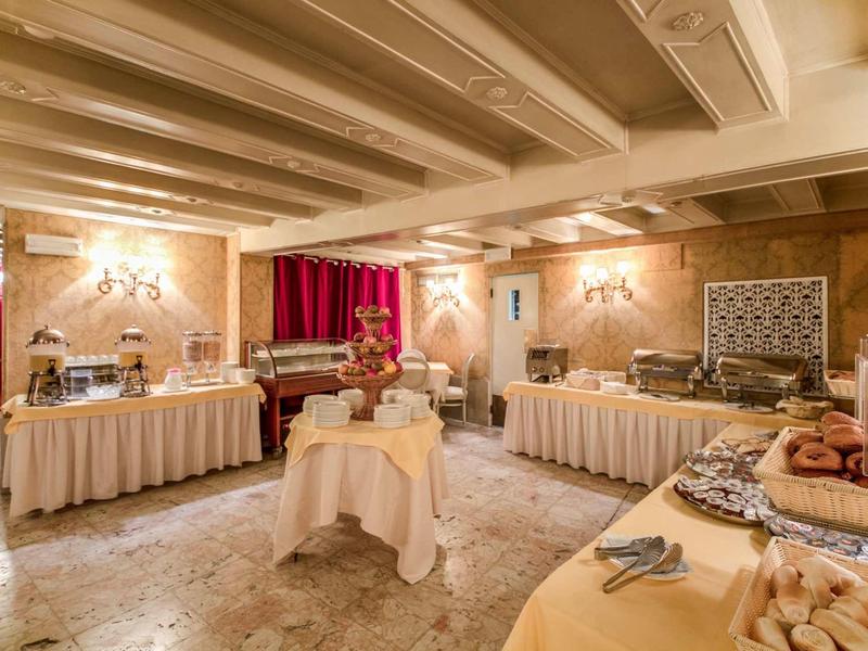 Elegant breakfast room with richly set buffets and classic decor.
