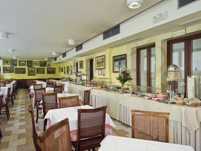 Large dining room with set tables and buffet along one wall.