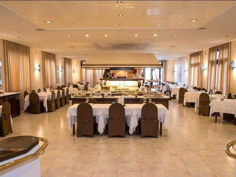 An elegant banquet hall with set tables and chairs, prepared for an event.