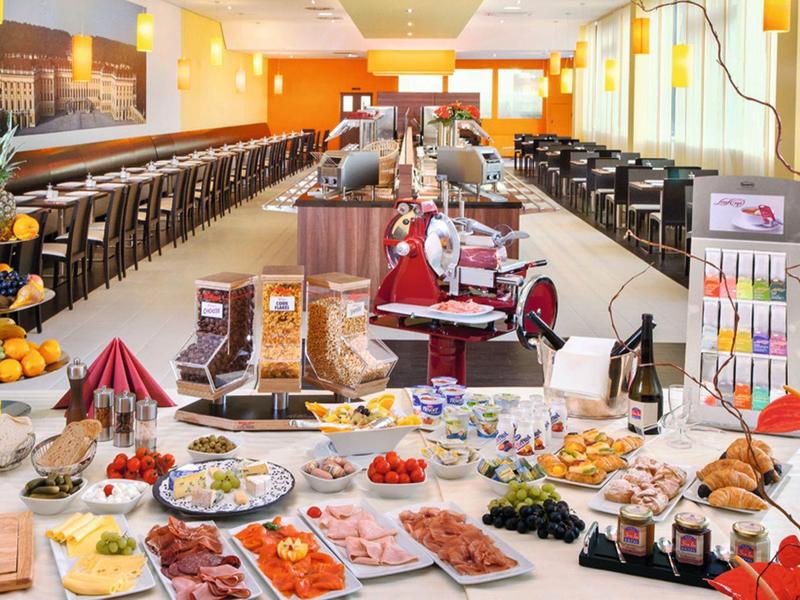 Buffet with a wide variety of cold and hot dishes in a bright dining room.