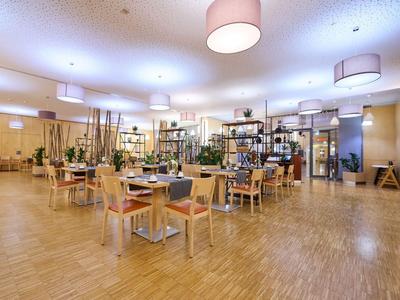 Bright, spacious dining area with wooden flooring and modern furniture.