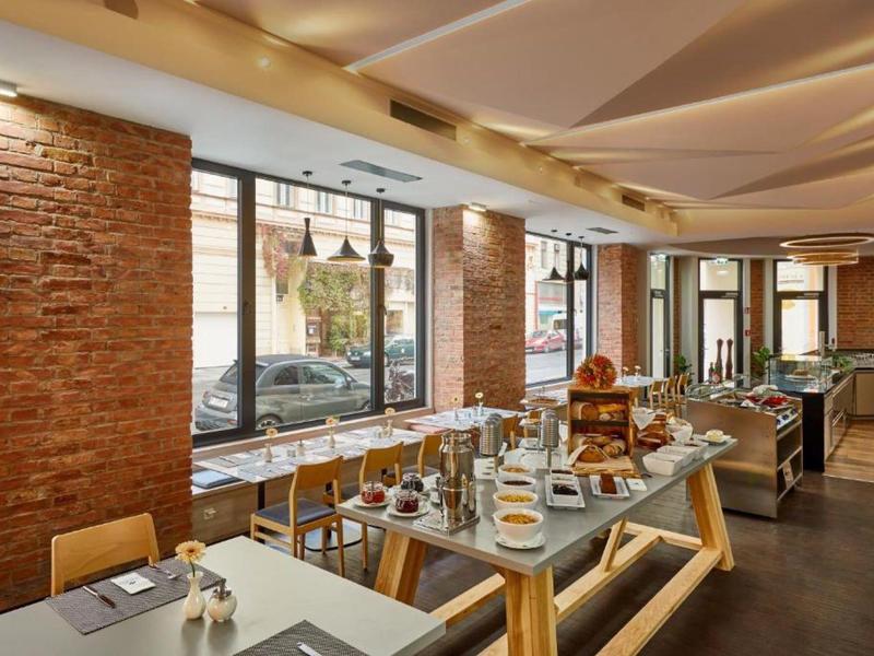 Modern dining room with rustic brick walls and elegantly set tables.