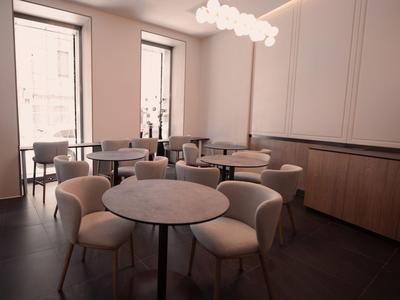 Salle à manger moderne avec tables rondes et chaises confortables aux tons chaleureux.