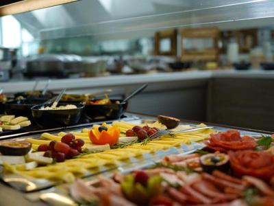 Buffet con una selezione di formaggi, affettati e frutta in un ristorante d'hotel.