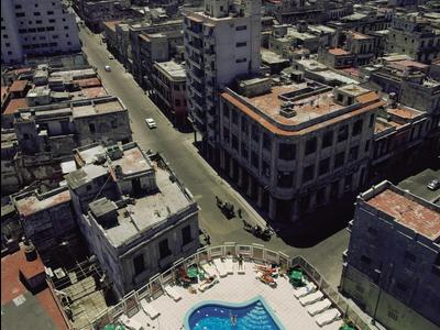 View of a city with multiple buildings and a hotel rooftop pool.