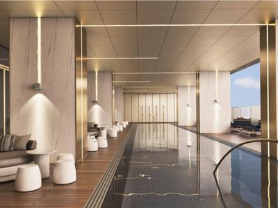 Modern indoor hotel pool with wooden ceiling and large window view.