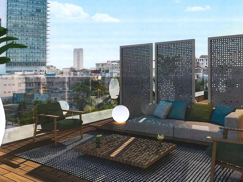 Modern rooftop terrace with cozy lounge, wooden furniture, and city view in daylight.