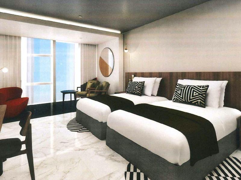 Modern hotel room with two beds and large windows.