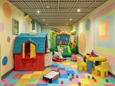 Colorful children's playroom with playhouse, bouncy castle, and toys on colorful floor.