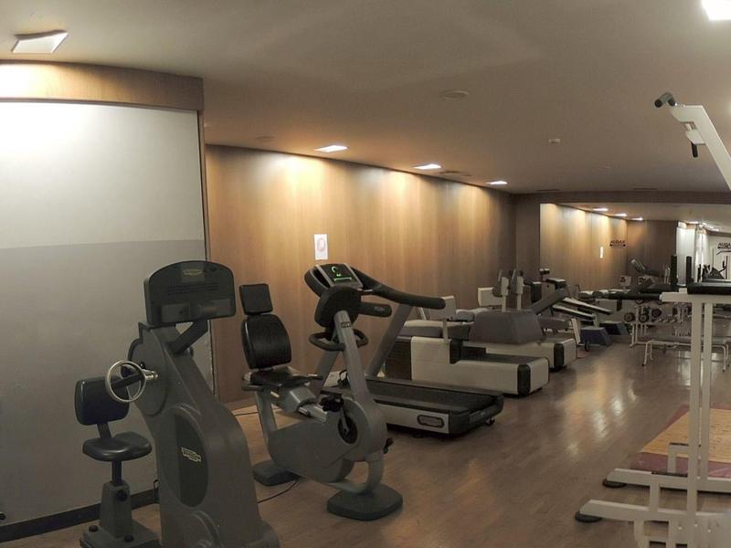 Hotel gym with various exercise machines and equipment.