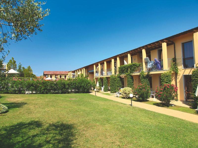 Hotel building with lawn and clear blue sky in the background