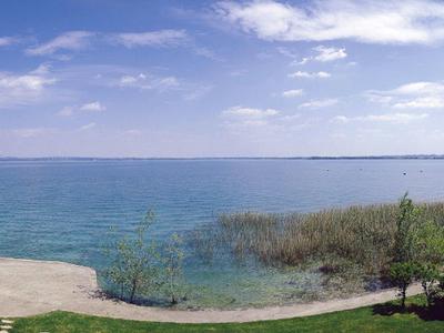 Clear sea with blue sky and vegetated shore areas on a sunny day